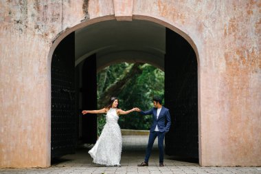  bir takım elbise dansları yakışıklı Hintli adam gün boyunca Asya'da bir parkta Çin onun nişanlısı ile. Irklararası çift yeni nişanlı ve alarak düğün fotoğrafları parkta olduğunu.