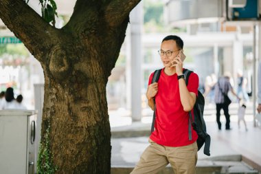 şehir içinde telefon olan orta yaşlı Asya adam