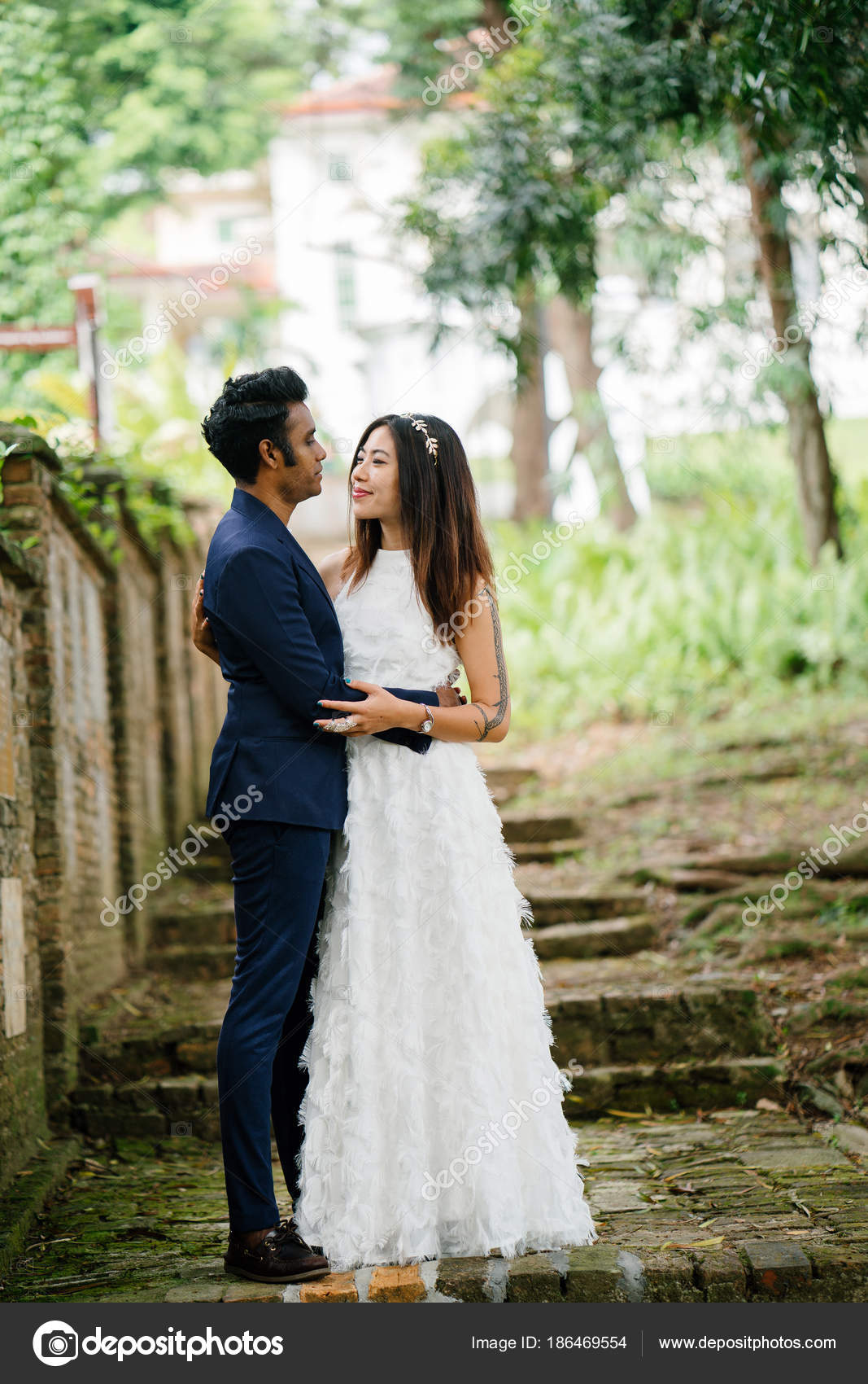 Interracial Couple Indian Man Chinese Woman Pose Wedding Photo