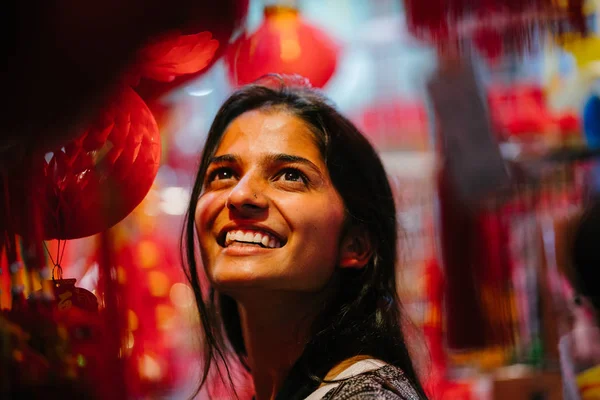 young Indian woman  at the night market during the Chinese New Year festival in Asia.