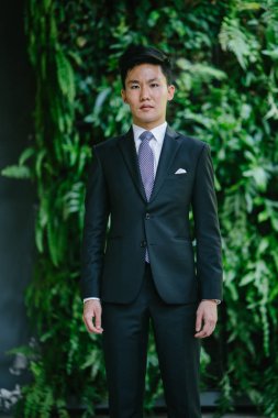 Bir profesyonel koyu takım elbise ve beyaz gömlek Asya adam portresi. O bir şık cep kare vardır