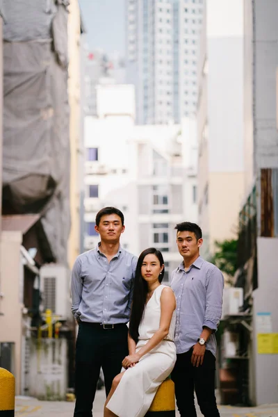 portrait of professional business people  on a street in a city in Asia.