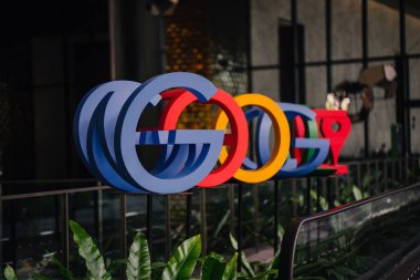 Singapur, Mart 2018: Google'nın yeni kampüs lobisinde Google logosu ve office bölgesel HQ Singapur fotoğrafı. Bir grup insan müzik chimes bir tekerlek çevirmek.