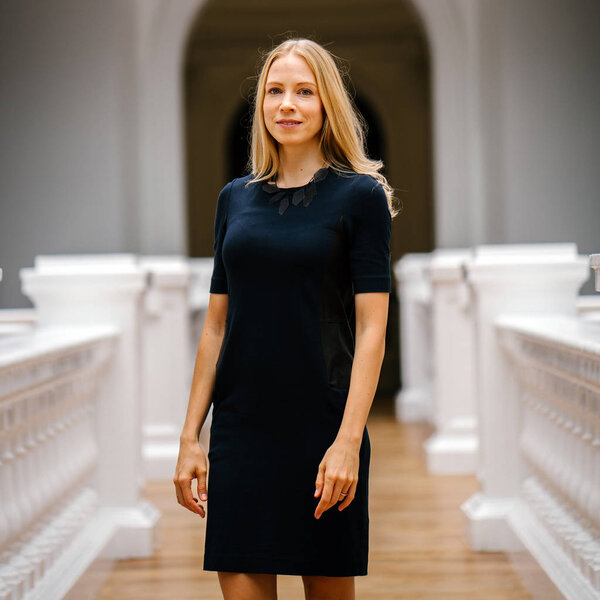 Portrait of a very beautiful white Caucasian woman in a black dress. She is blond with blue eyes, middle-aged, attractive, beautiful and smiling. She is a Russian expatriate living in Singapore.