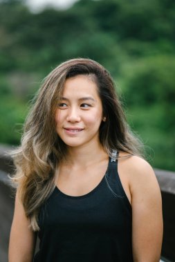 Çekici, genç Çinli Asyalı bir kadın portresi sportif, aktif giyim Singapur genel Park'ta hafta sonu gün içinde giyinmiş.