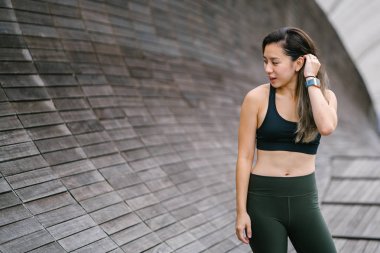 Çekici, genç Çinli Asyalı bir kadın portresi sportif, aktif giyim Singapur genel Park'ta hafta sonu gün içinde giyinmiş.