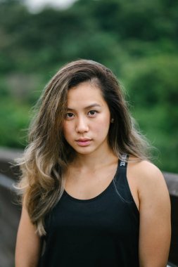 Çekici, genç Çinli Asyalı bir kadın portresi sportif, aktif giyim Singapur genel Park'ta hafta sonu gün içinde giyinmiş.