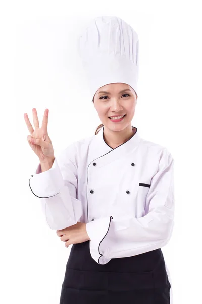 Chef feminino feliz, sorridente e positivo apontando quatro dedos — Fotografia de Stock