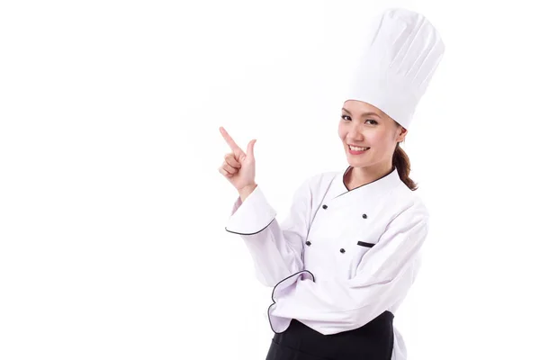 Chef feminino feliz, sorridente e positivo apontando para cima — Fotografia de Stock