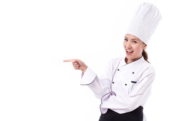 Lycklig, leende, positiva kvinnliga kock pekar sideway — Stockfoto