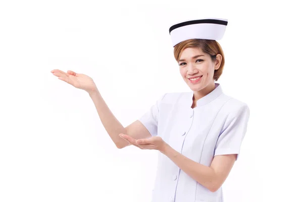 Smiling female nurse presenting, showing her hand to blank space — Stock Photo, Image