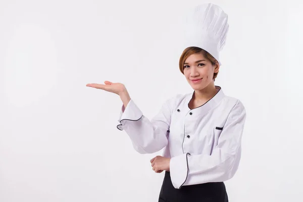 Feminino ásia chef apontando ela mão para o lado — Fotografia de Stock