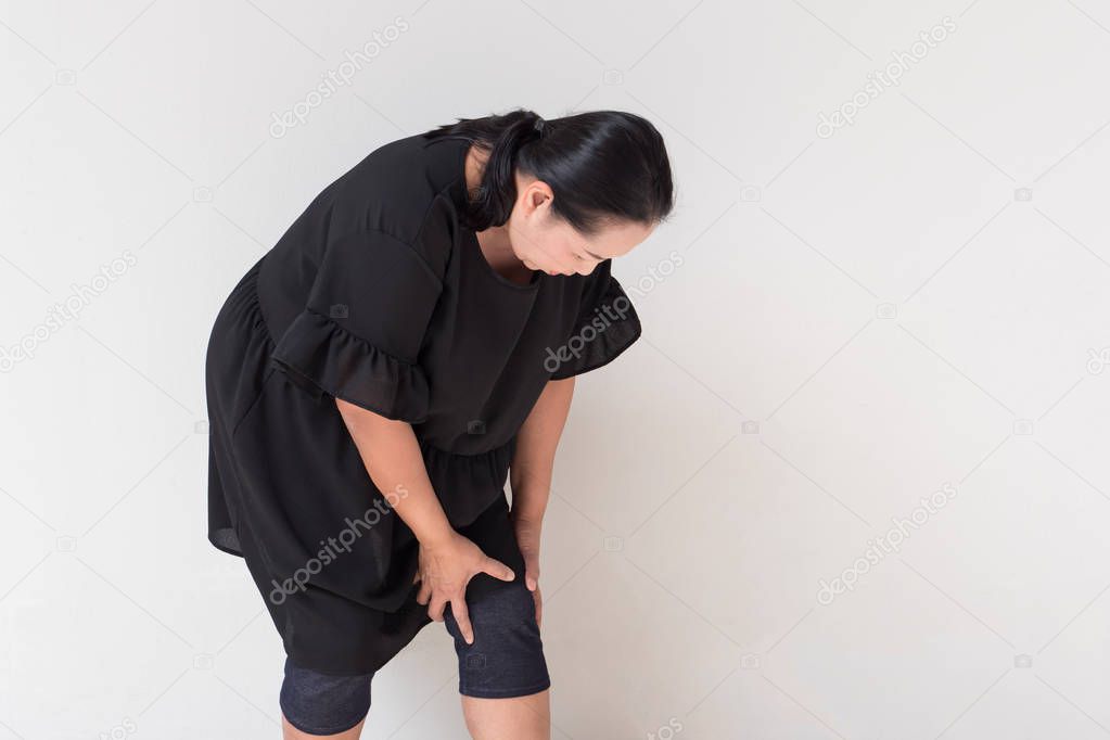 middle aged woman suffering from knee pain, joint injury or arthritis
