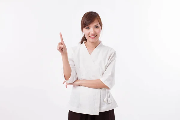Mulher terapeuta spa apontando para cima 1 dedo, contagem, numeração — Fotografia de Stock