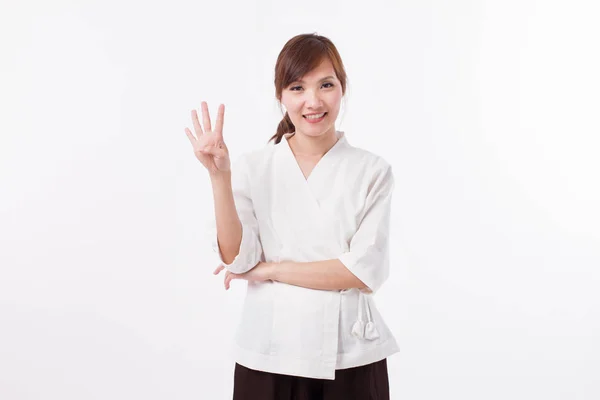 Donna terapeuta spa indicando 4 dita, conteggio, numerazione — Foto Stock