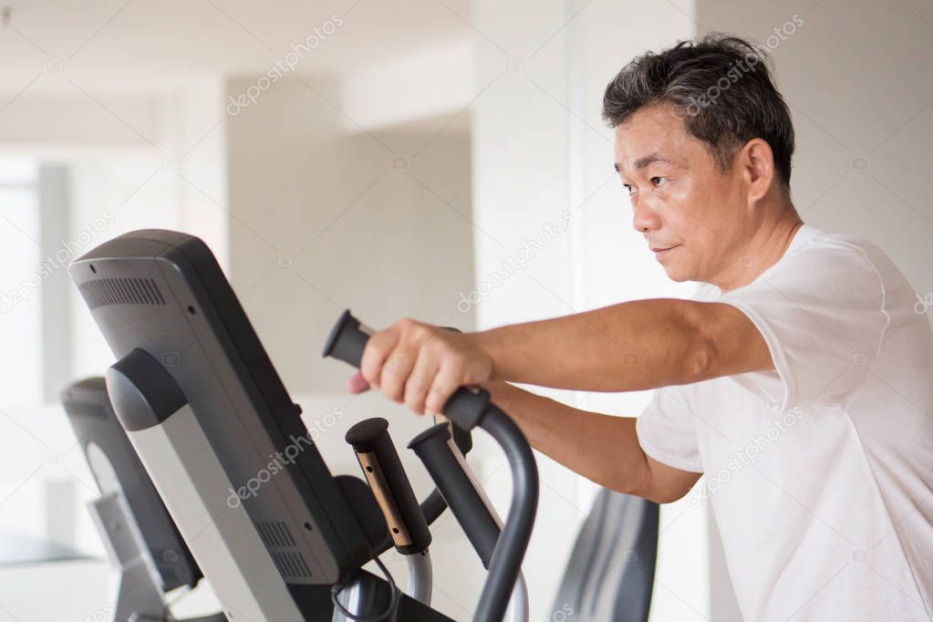 old senior man working out with modern equipment