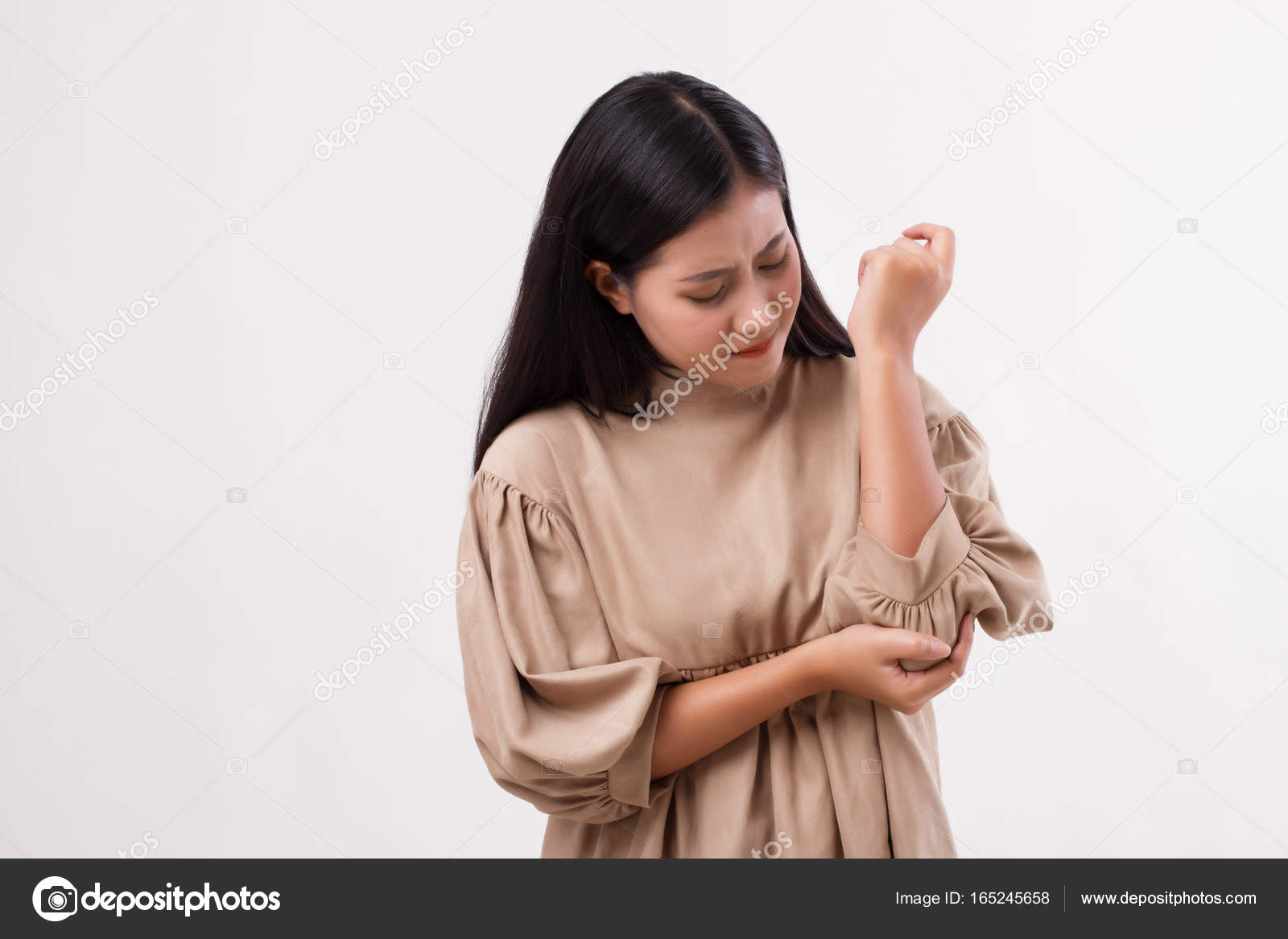 Woman suffering from elbow joint pain, rheumatoid or gout arthri Stock