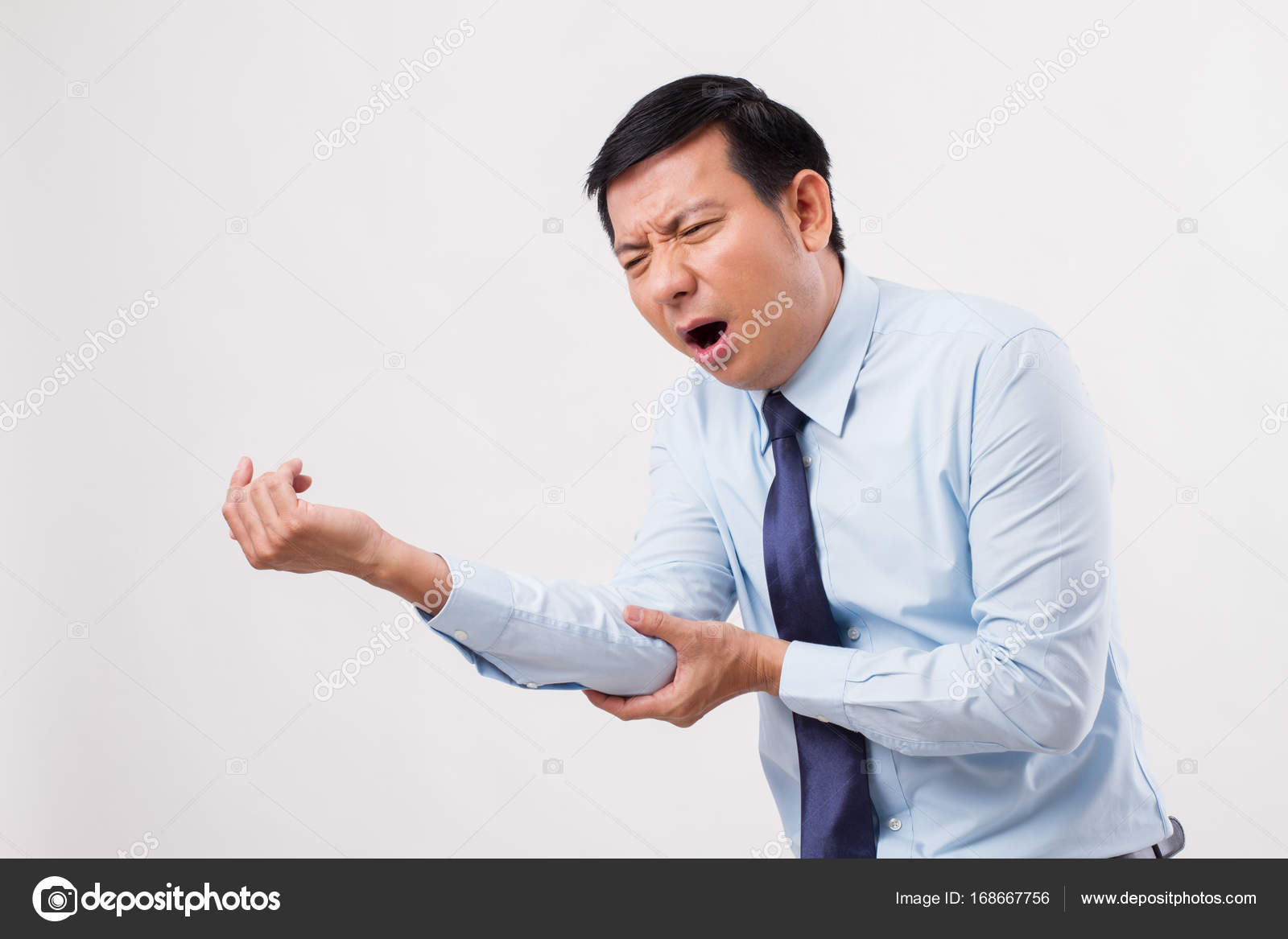 Man suffering from elbow joint pain, gout arthritis ⬇ Stock Photo