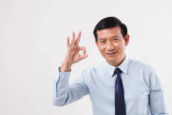 Businessman pointing up ok hand gesture — Stock Photo, Image
