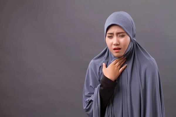 sick muslim woman coughing with cold or sore throat