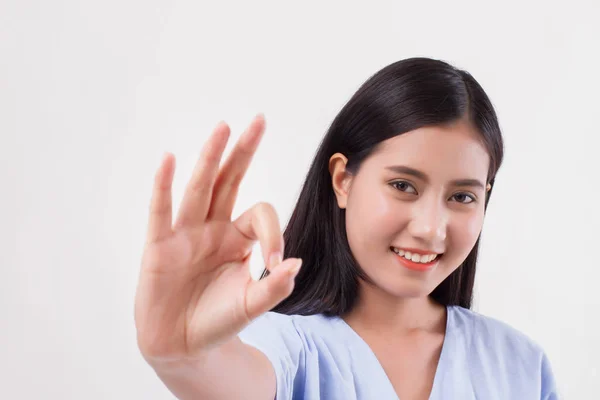 Injured woman patient pointing up ok hand gesture — Stock Photo, Image