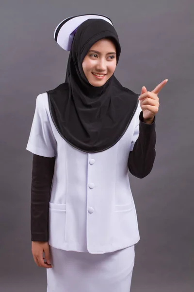 Enfermeira muçulmana apontando para cima dedo — Fotografia de Stock