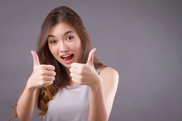 Exited woman giving double thumb up studio isolated portrait — Stock Photo, Image