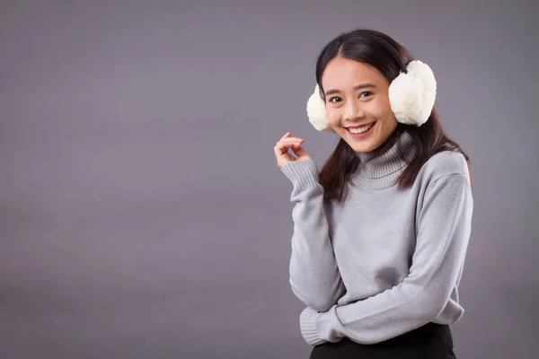Happy smiling asian woman with earmuffs — Stock Photo, Image