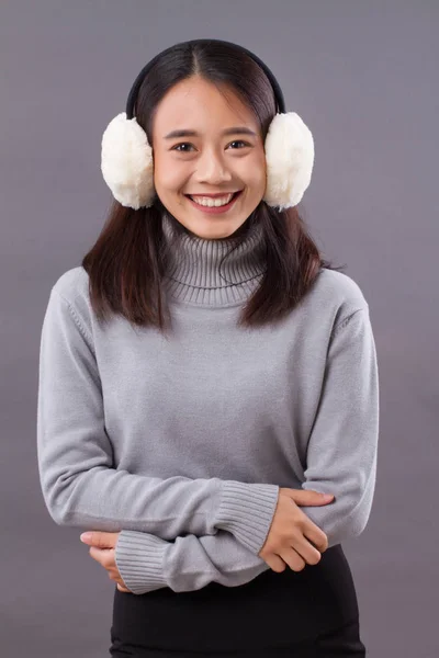 Happy smiling asian woman with earmuffs — Stock Photo, Image