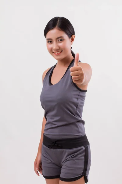 Confident happy smiling fitness woman giving thumb up — Stock Photo, Image