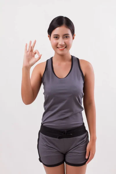 Confident happy smiling fitness woman giving ok hand gesture — Stock Photo, Image