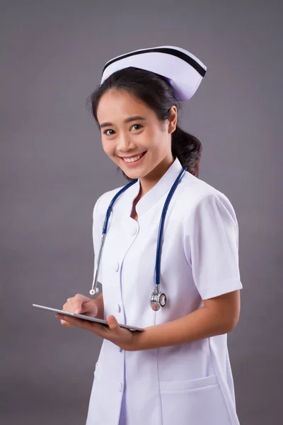 modern nurse using computer tablet, digital patient record concept