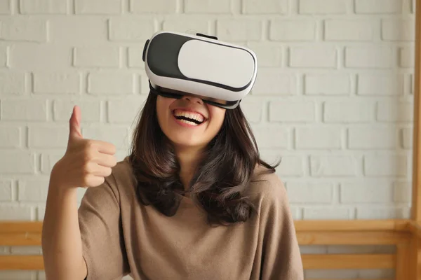 woman with vr headset giving thumb up gesture