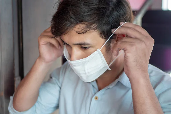 man wearing air filter mask in unhealthy, danger, polluted air environment