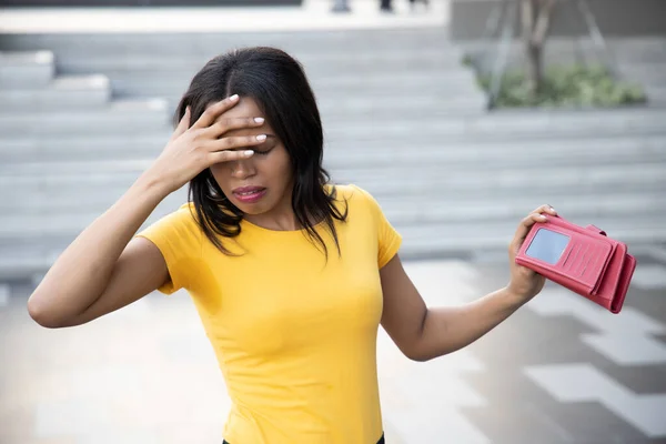 African woman without money; portrait of poor black African woman with empty wallet, poor people, poverty, bankruptcy, financial broke, unemployment, joblessness; no credit, no money concept