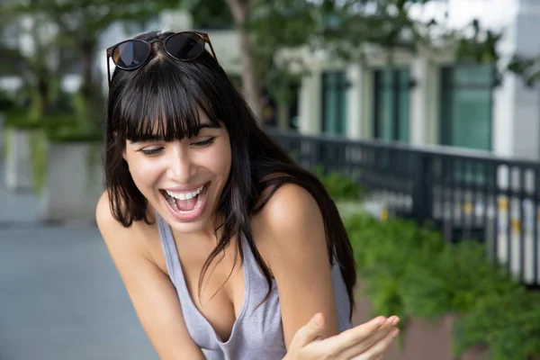 South American girl with laughing face; happy laughing hispanic woman portrait with friendly face expression; Brazilian latin American woman model