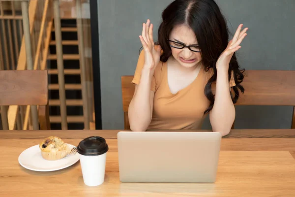 angry asian business woman; upset angry woman office worker working at home; concept of business in epidemic crisis, social distancing, physical distancing practice, problem with work from home