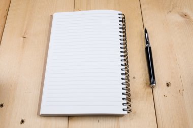 kalem ve kitap ahşap arka plan üzerinde