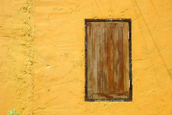 Wooden window in colorful wall — Stock Photo, Image