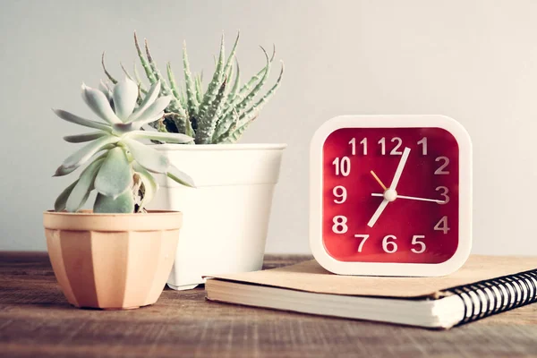 Reloj despertador en la mesa de madera con efecto filtro estilo vintage retro —  Fotos de Stock