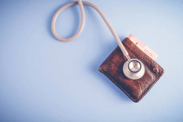 save money for investment concept Stethoscope and money  with filter effect retro vintage style