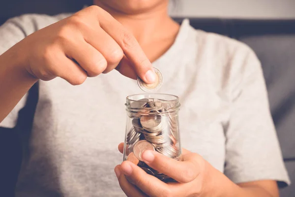 Save money for investment concept Hand holding money in jar with filter effect retro vintage style — Stock Photo, Image