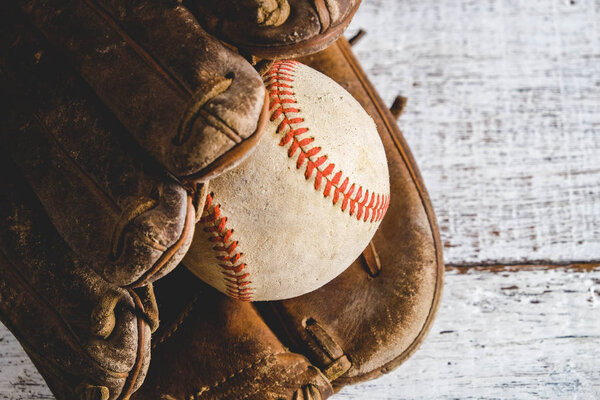 old Baseball and glove on wood background with filter effect retro vintage style