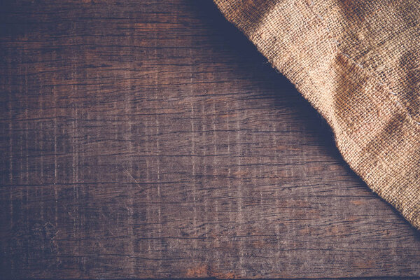 Wood table with old sackcloth burlap tablecloth texture with filter effect retro vintage style