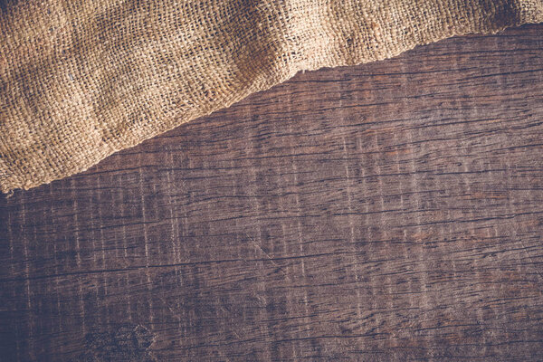 Wood table with old sackcloth burlap tablecloth texture with filter effect retro vintage style