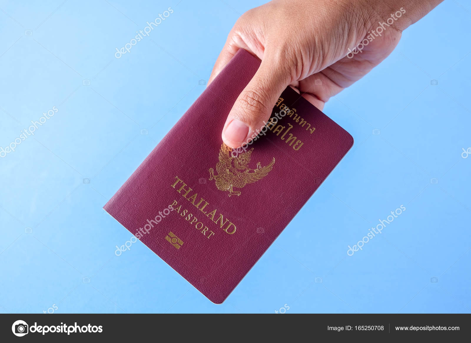 Thailand Passport Brown Cover On Blue Paper Background For.