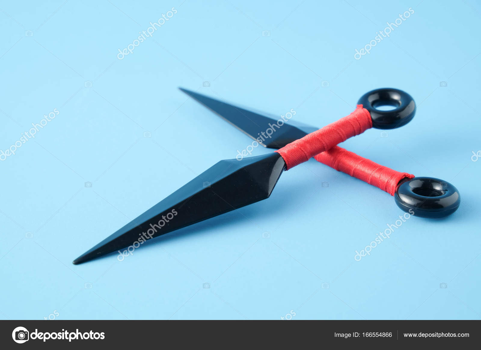 To throw ninja weapons isolated on blue paper background Stock Photo by