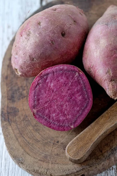 Filtre etkisi retro v ile ahşap arka plan üzerinde ham tatlı patates