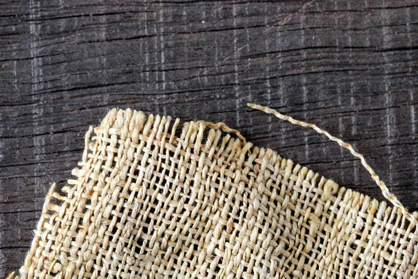 Wood table with old sackcloth burlap tablecloth texture — Stock Photo, Image