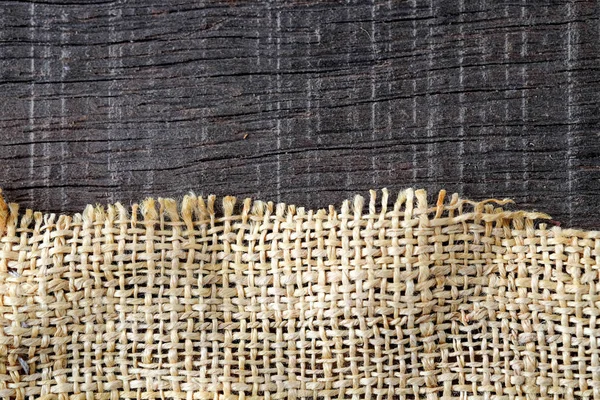 Wood table with old sackcloth burlap tablecloth texture — Stock Photo, Image